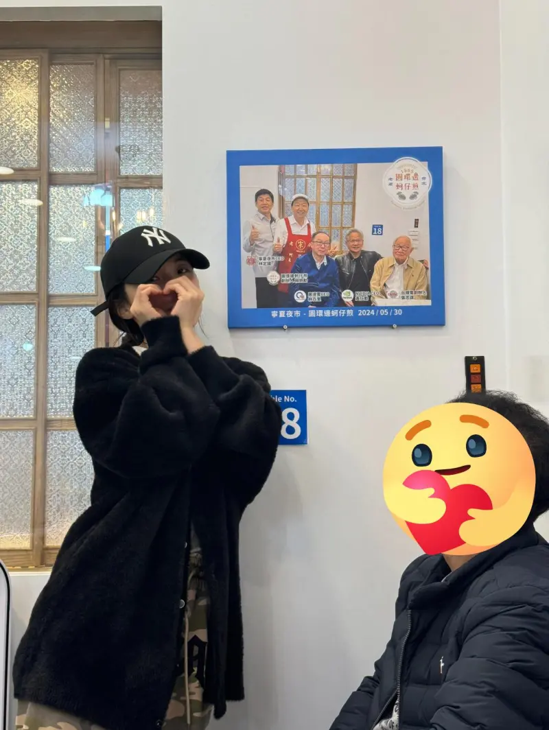 ▲李多慧朝聖黃仁勳推薦的蚵仔煎店,還在黃仁勳照片前拍照打卡。(圖/李多慧臉書)