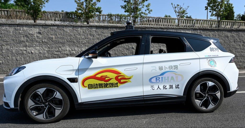 The photo taken on July 17, 2023 shows a driverless robotaxi autonomous vehicle developed by Baidu Apollo driving along a street in Beijing. (Photo by Jade Gao / AFP) (Photo by JADE GAO/AFP via Getty Images)