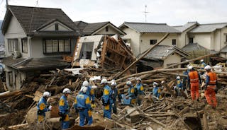 Fire-fighters and police officers search for survivors at a site where a landslide swept through a residential area at Asaminami
