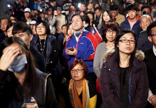 Supporters react as KMT presidential candidate Eric Chu concedes defeat in the elections in Taipei
