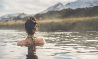 Girl in a hot spring in Iceland Landmannalaugar