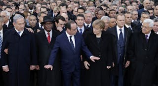 French President Francois Hollande is surrounded by heads of state attends the solidarity march (Marche Republicaine) in the str