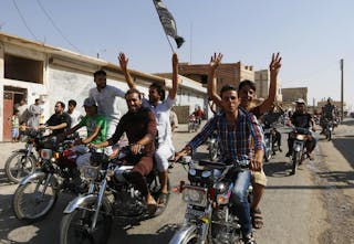 Residents of Tabqa city tour the streets on motorcycles, carrying flags in celebration after Tabqa air base fell to Islamic Stat