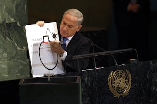 Israeli Prime Minister Benjamin Netanyahu draws a red line on an illustration as he addresses the 67th United Nations General As