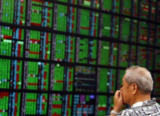 A man looks at stock market monitors inside a bank in Taipei September 11, 2008. Taiwan stocks fell 2 percent on Thursday, hurt by TSMC after the chip maker reported its sales growth rate continued to slow in August, with investors ignoring a government move to halve the stock transaction tax. The Taiwan dollar also weakened beyond the key T$32 psychological barrier to a seven-month low on Thursday as the stock market fell after the cut in the stock transaction tax failed to boost sentiment. REUTERS/Nicky Loh (TAIWAN) - RTX8NJL