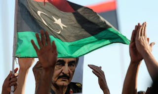 A picture of General Khalifa Haftar is seen next to a Libyan flag during a demonstration in support of "Operation Dignity" in Be