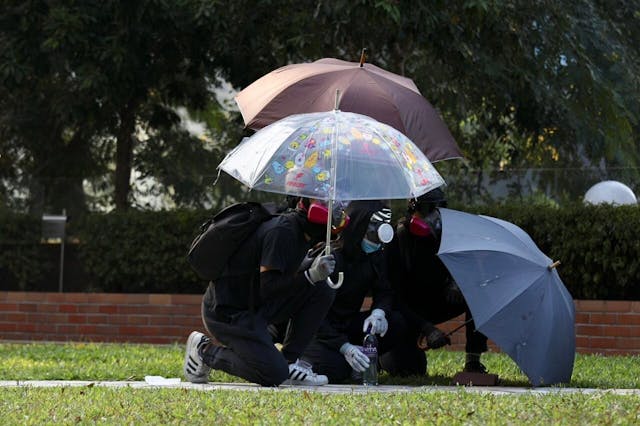 學生開雨傘遮擋。