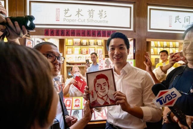 蔣萬安逛上海名勝豫園，展示剪紙師傅給他剪的頭像。（蔣萬安社交平台）