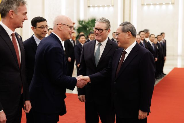 29/01/2026. Beijing, China. Ambassador Peter Wilson shakes China's Premier Li Qiang hand at the Great Hall of the People. Picture by Simon Dawson / No 10 Downing Street